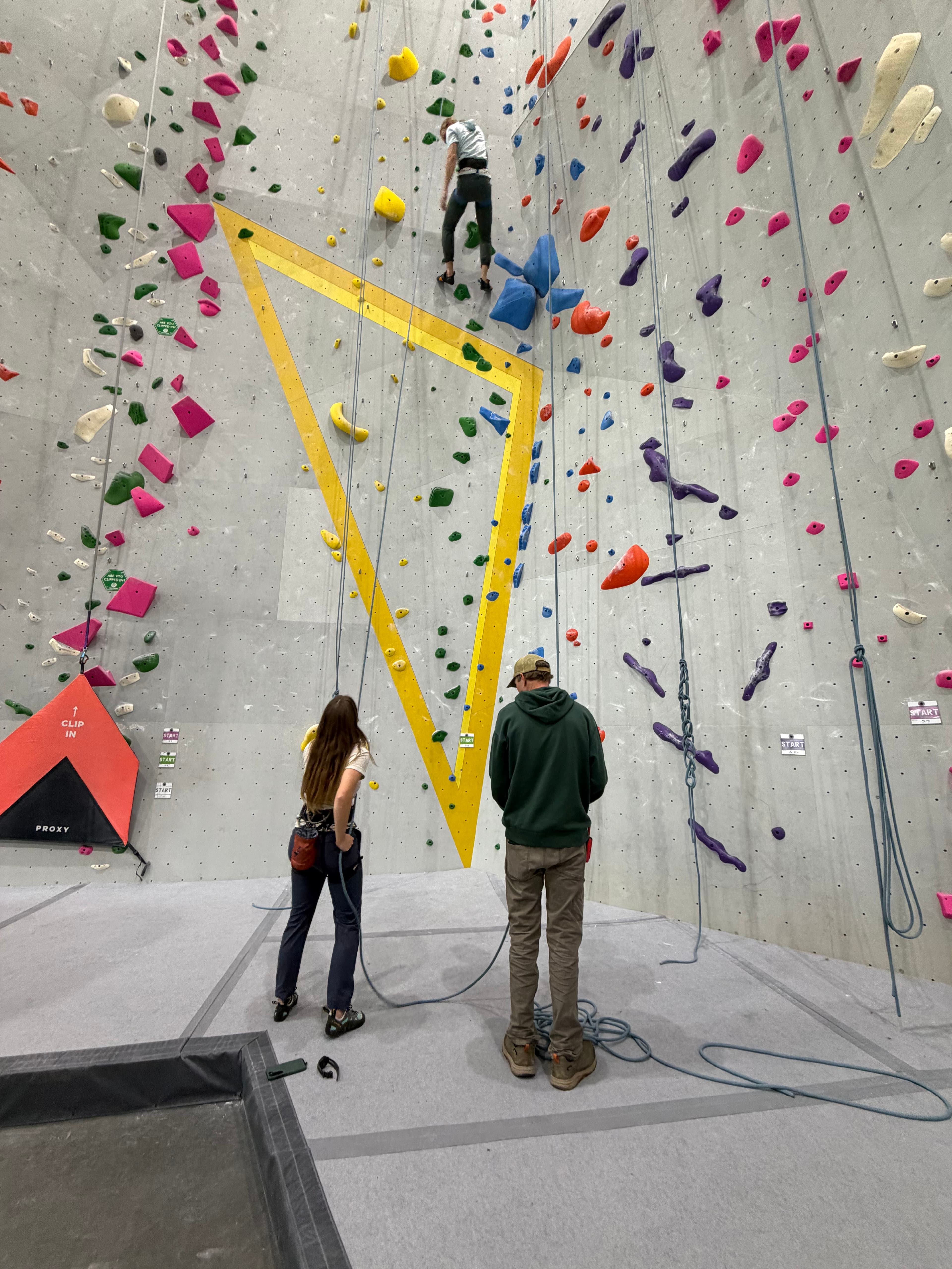 Climber topping out on a boulder problem
